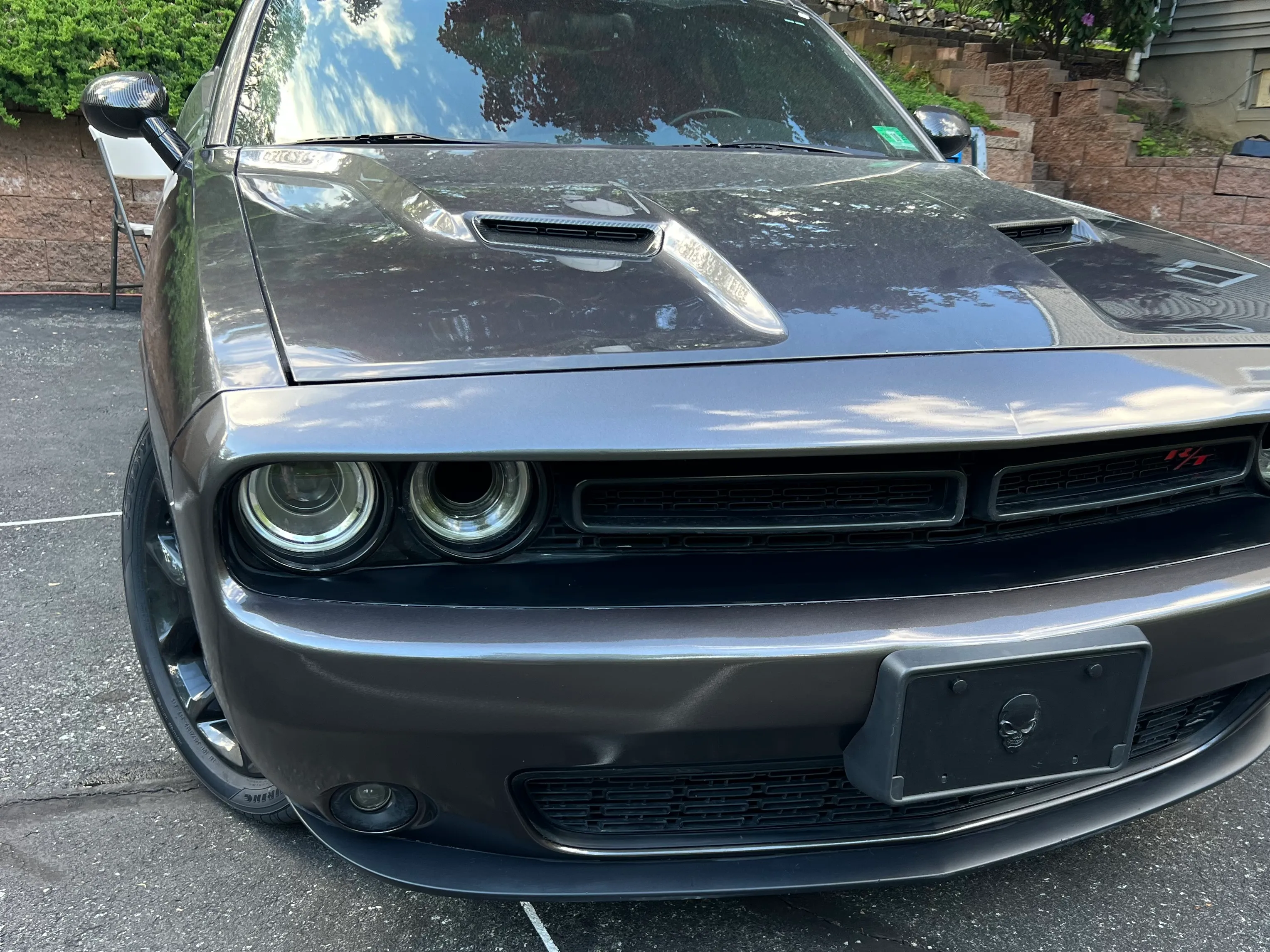 Full front view of the gray Dodge Challenger after repair, bumper refinished and clean.